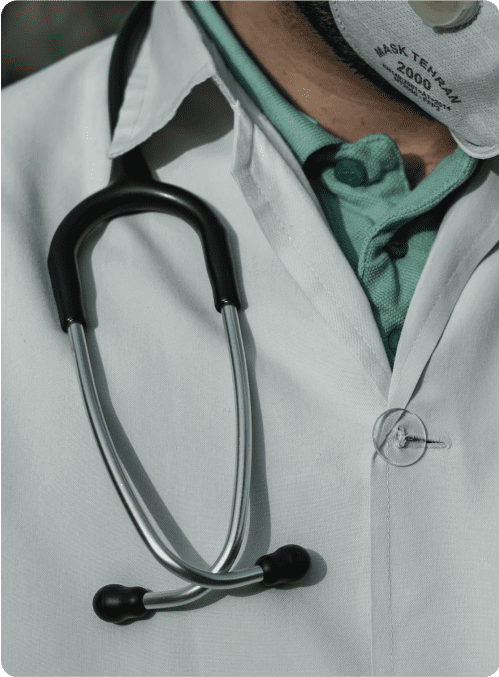 Close-up of a doctor wearing a white coat and stethoscope.